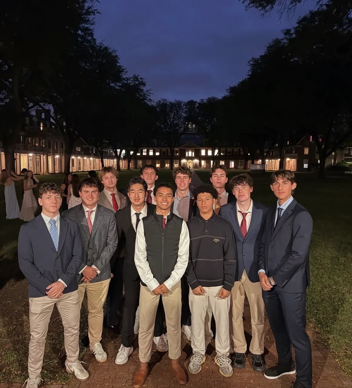 Georgii Demkin standing outdoors with his soccer teammates at dusk